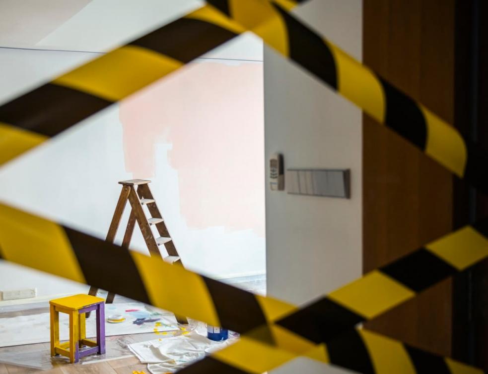 logement en cours de rénovation, chantier interdit marqué par des bandes noires et jaunes.